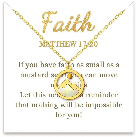 Gold necklace with a mountain-shaped pendant displayed on a white card that reads 'Faith' and Matthew 17:20 with inspirational text.