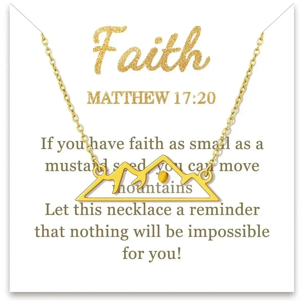 Gold necklace with mountain design on a card with inspirational text