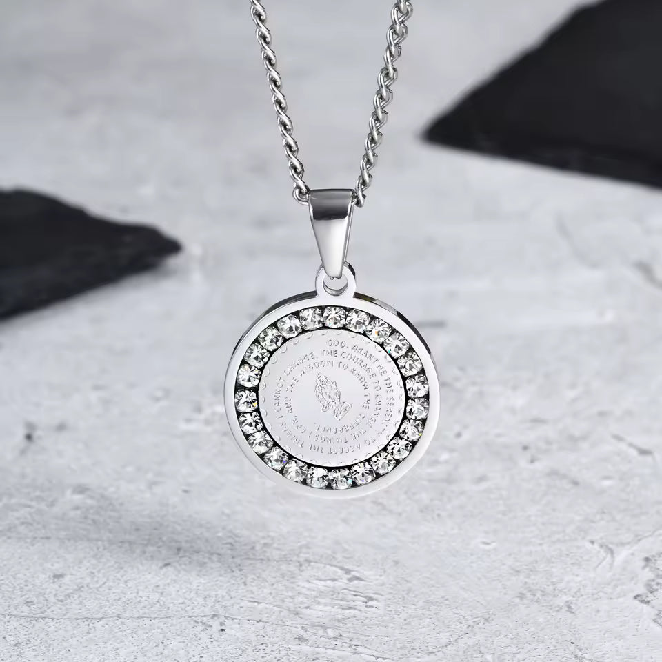 Silver necklace with a round pendant on a textured surface