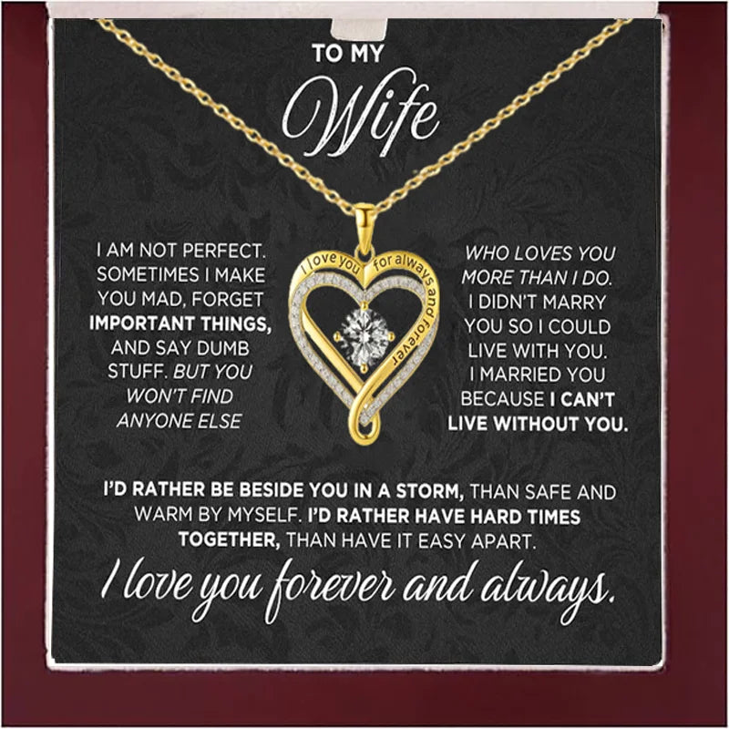 Heart-shaped necklace with sentimental message card for wife on a dark background