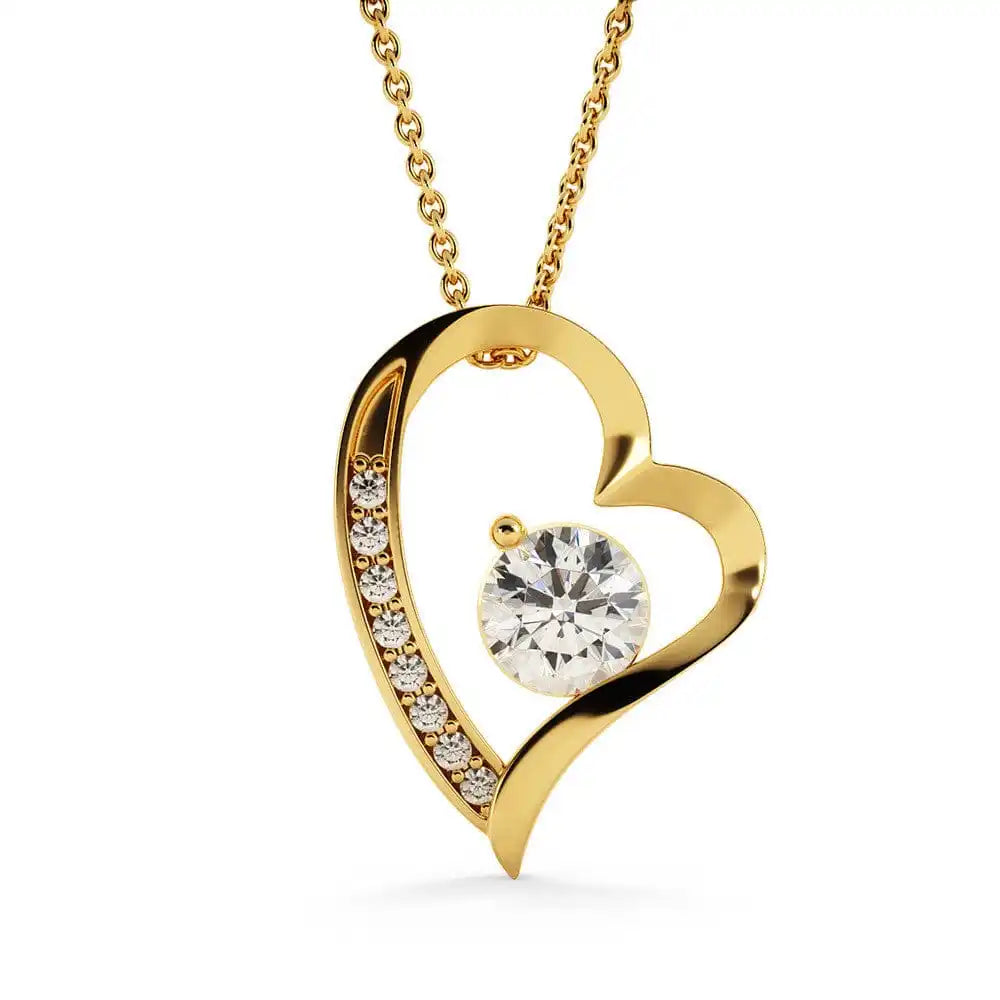 Gold heart-shaped necklace with a diamond on a white background