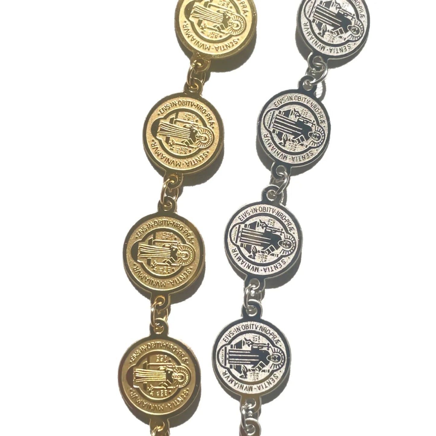 Pair of gold and silver bracelets with circular designs on a white background