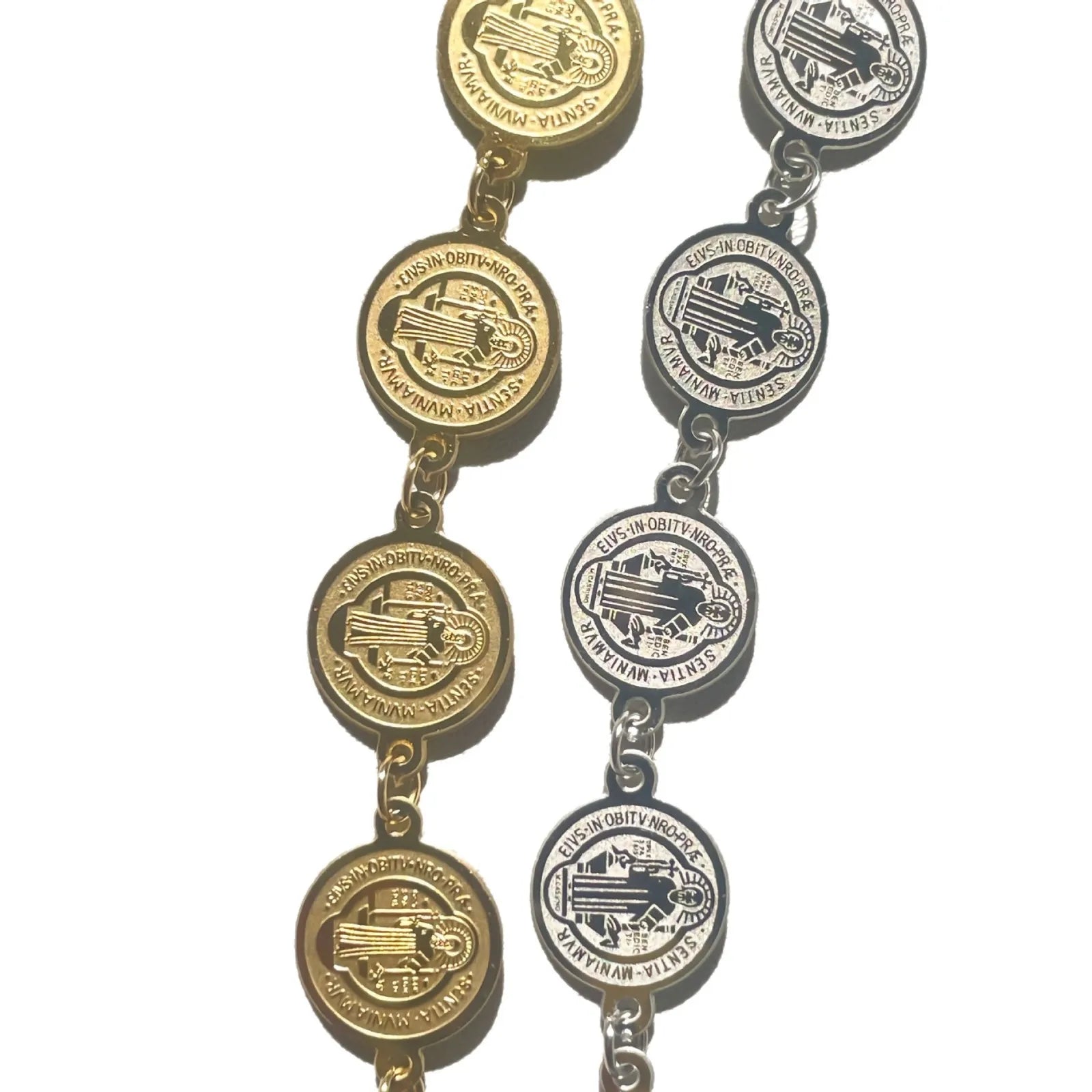 Pair of gold and silver bracelets with circular designs on a white background