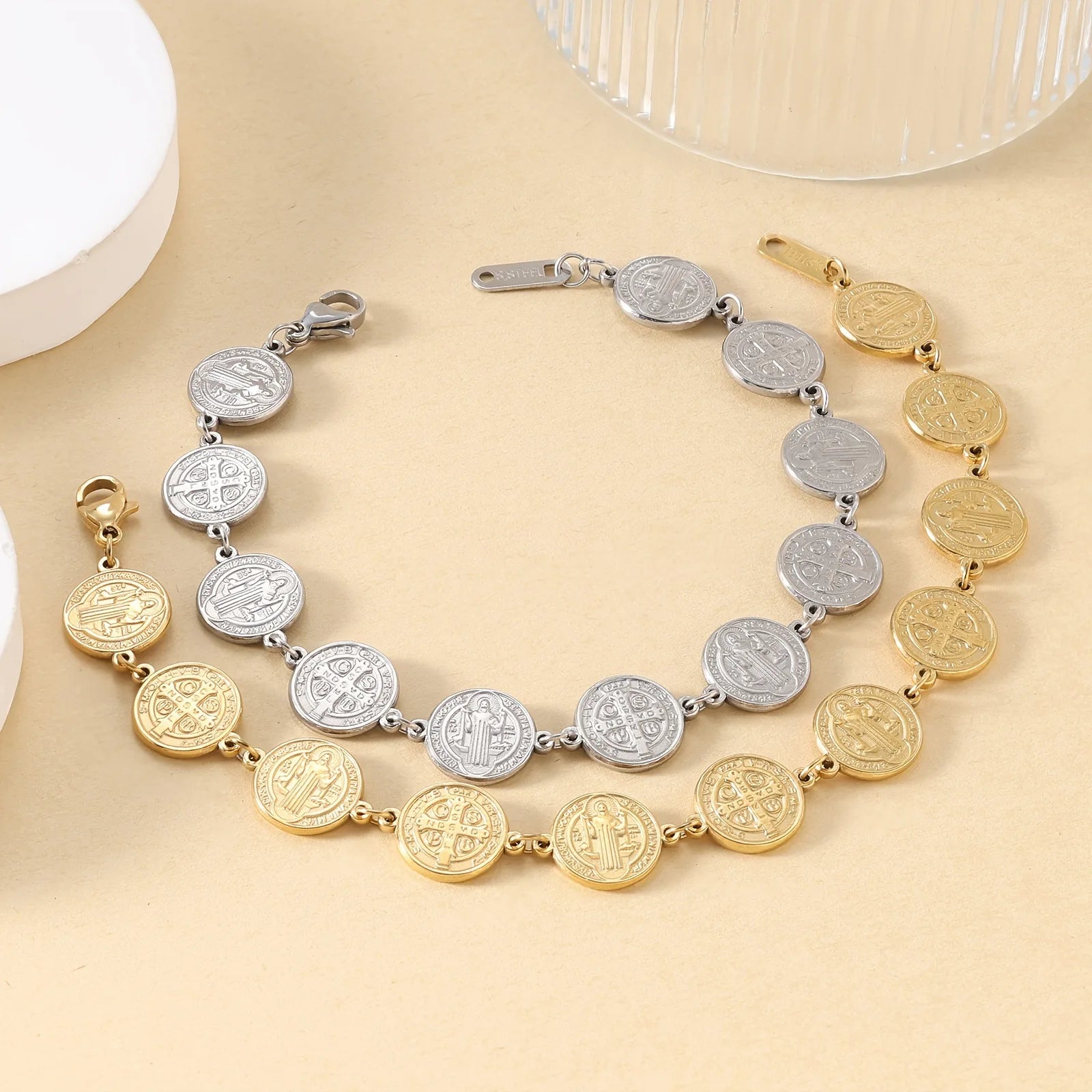 Two necklaces with coin-style beads on a beige surface