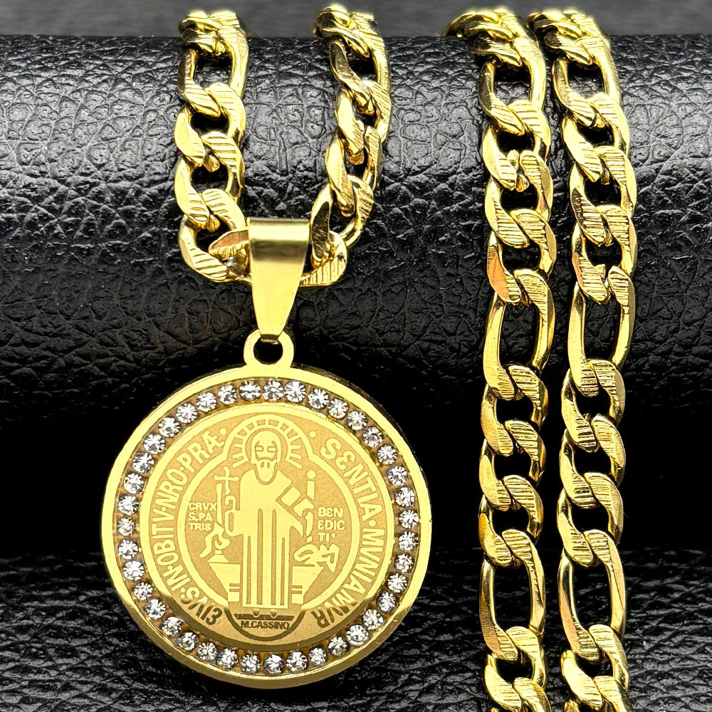 Gold necklace with a medallion and chain on a black textured background