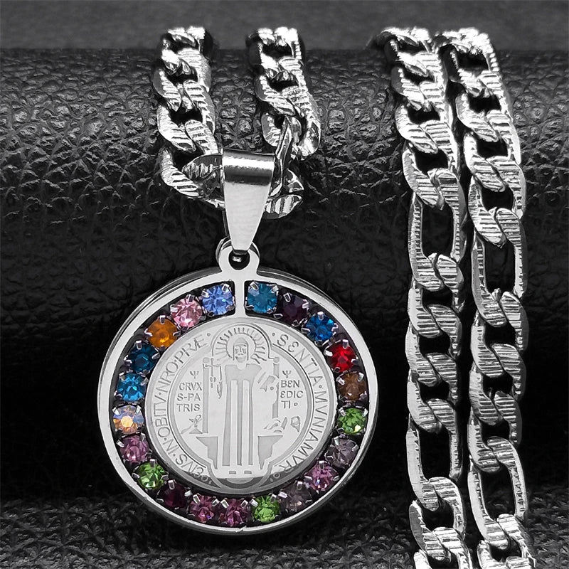 Silver necklace with a round pendant featuring colorful stones on a textured black background