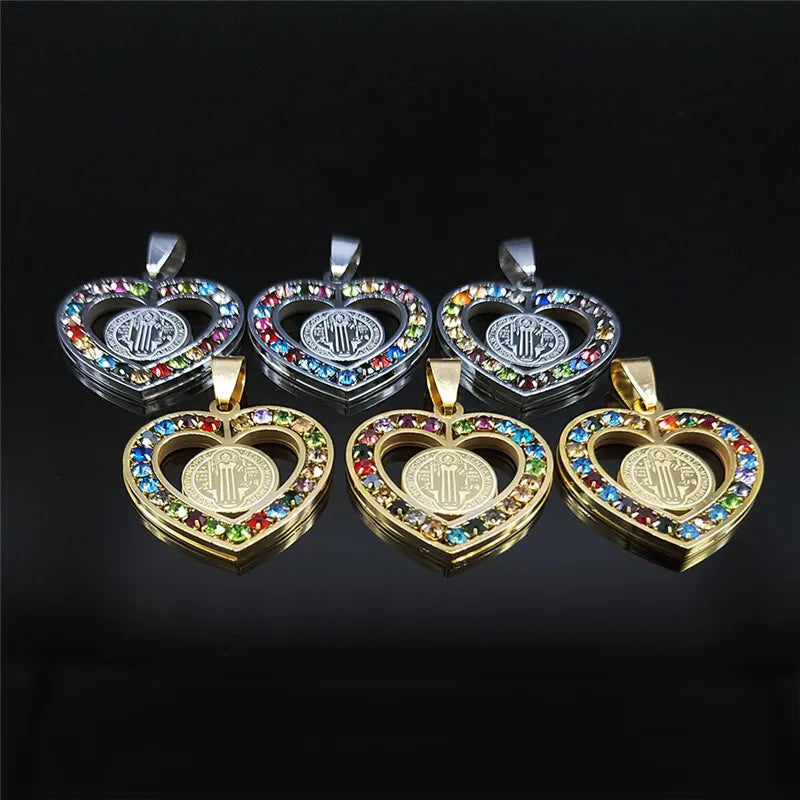 Set of heart-shaped pendants with colorful stones on a black background