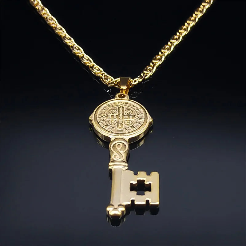 Gold key-shaped pendant on a chain against a dark background