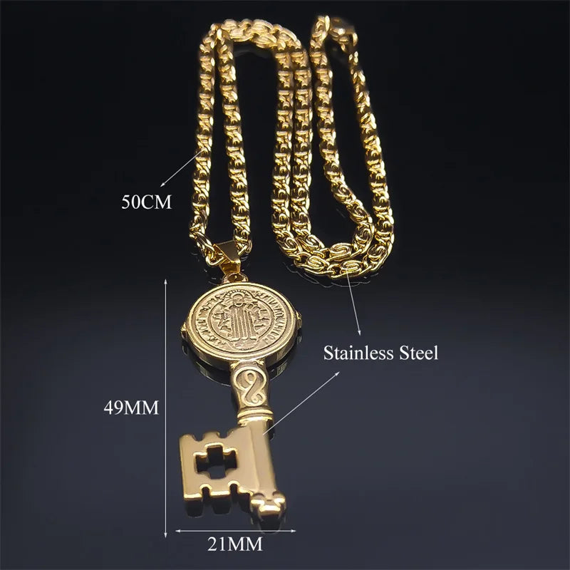 Gold key-shaped pendant necklace with measurements on a dark background