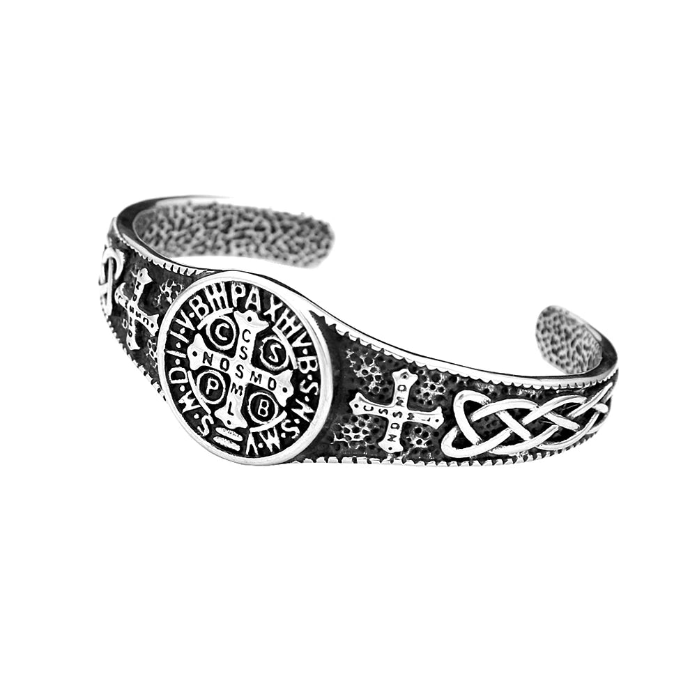 Silver bracelet with intricate designs on a white background