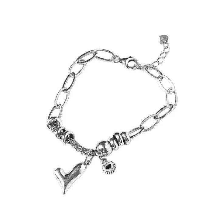 Silver bracelet with charms on a white background