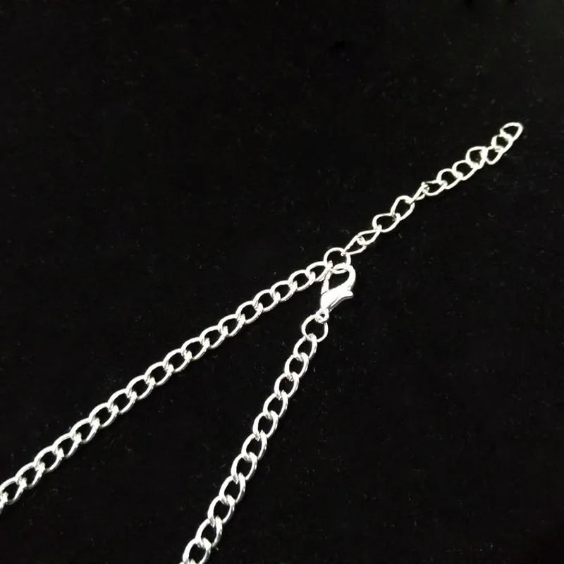 Silver chain necklace on a black background