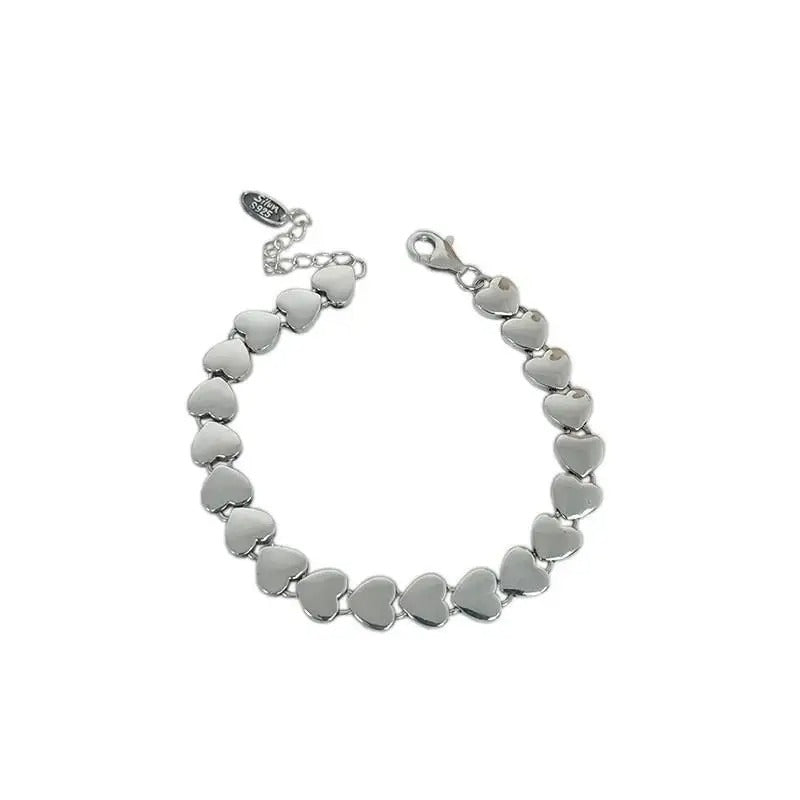 Silver heart-shaped bracelet on a white background