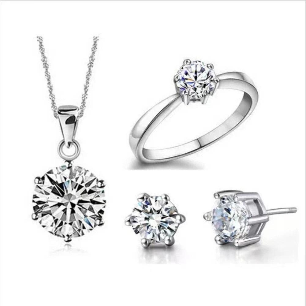 Silver jewelry set with necklace, ring, and earrings on a white background