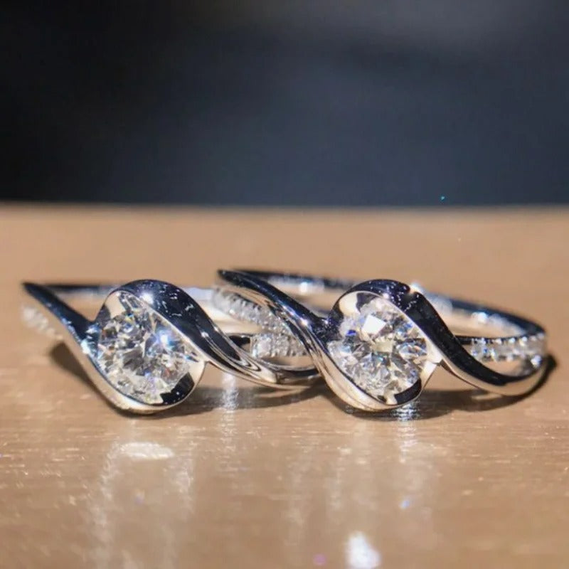 Silver ring with diamond stones on a wooden surface