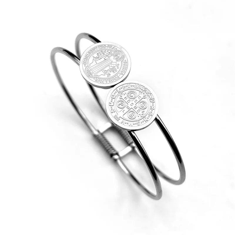 Silver bracelet with circular emblem on a white background