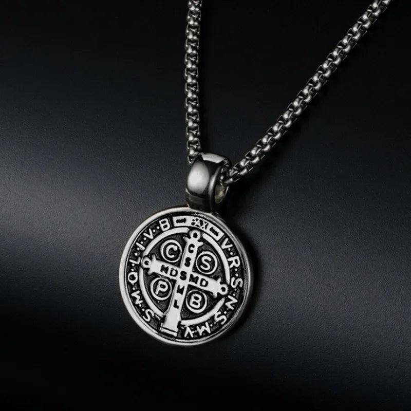 Silver necklace with a detailed pendant on a dark background