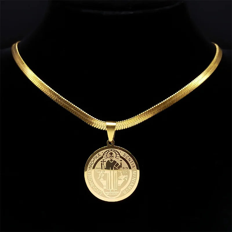 Gold necklace with a round pendant on a black background