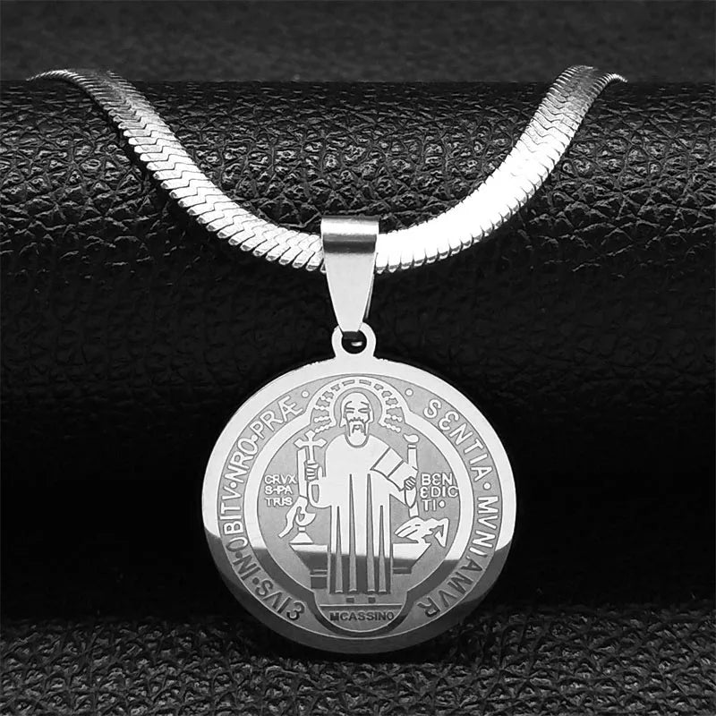 Silver necklace with a round pendant on a black textured background