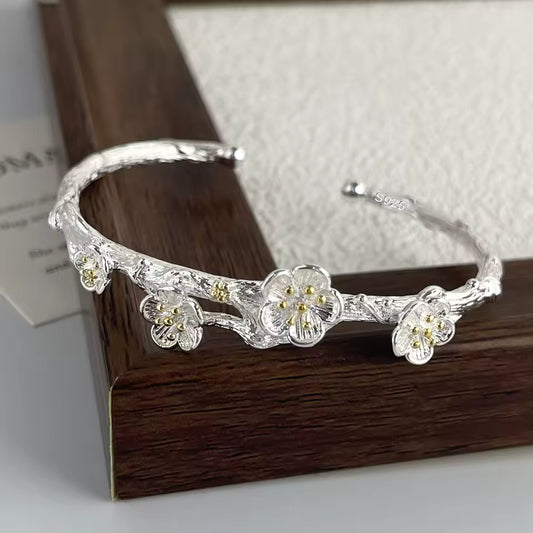 Silver floral headband on a wooden surface