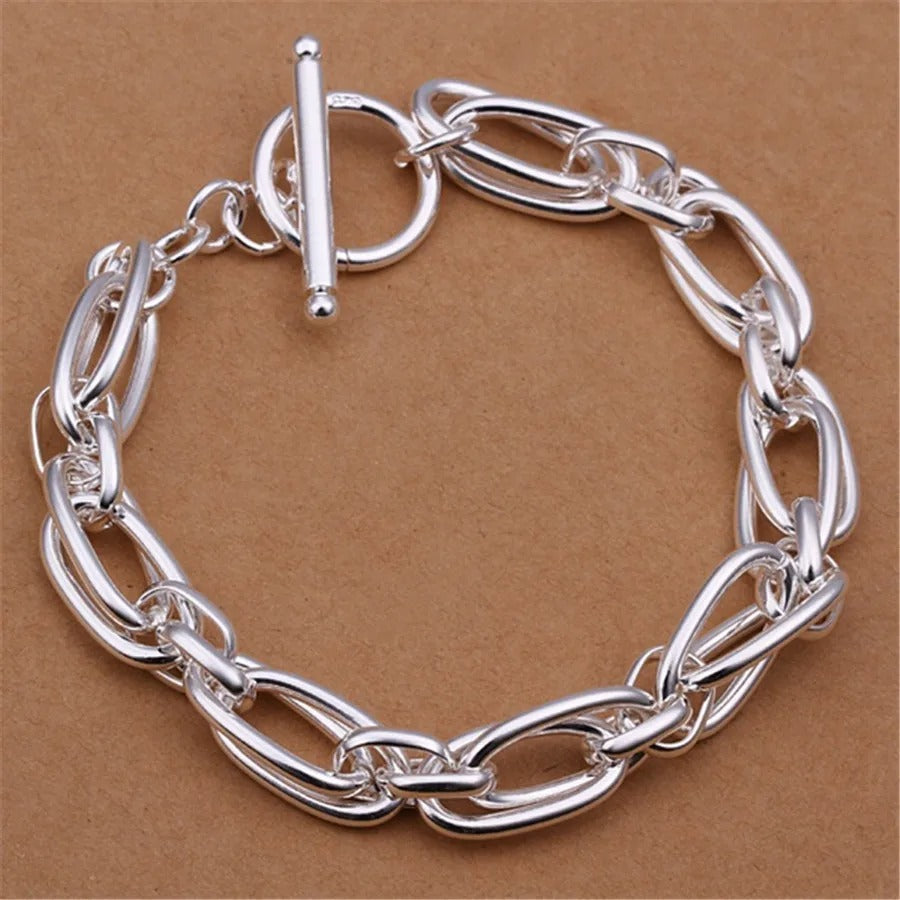 Silver chain bracelet on a brown background