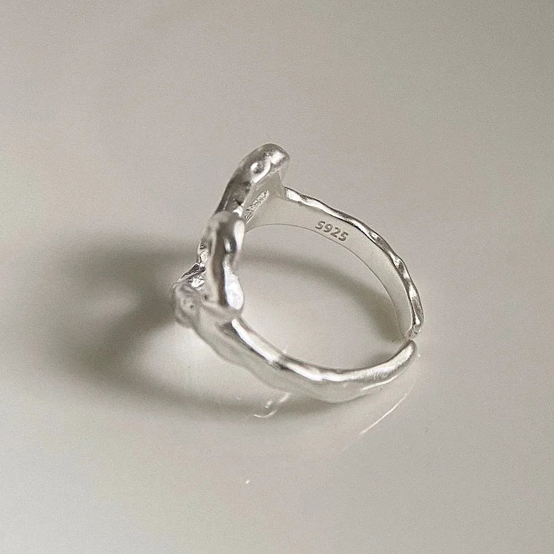 Silver ring on a light gray background