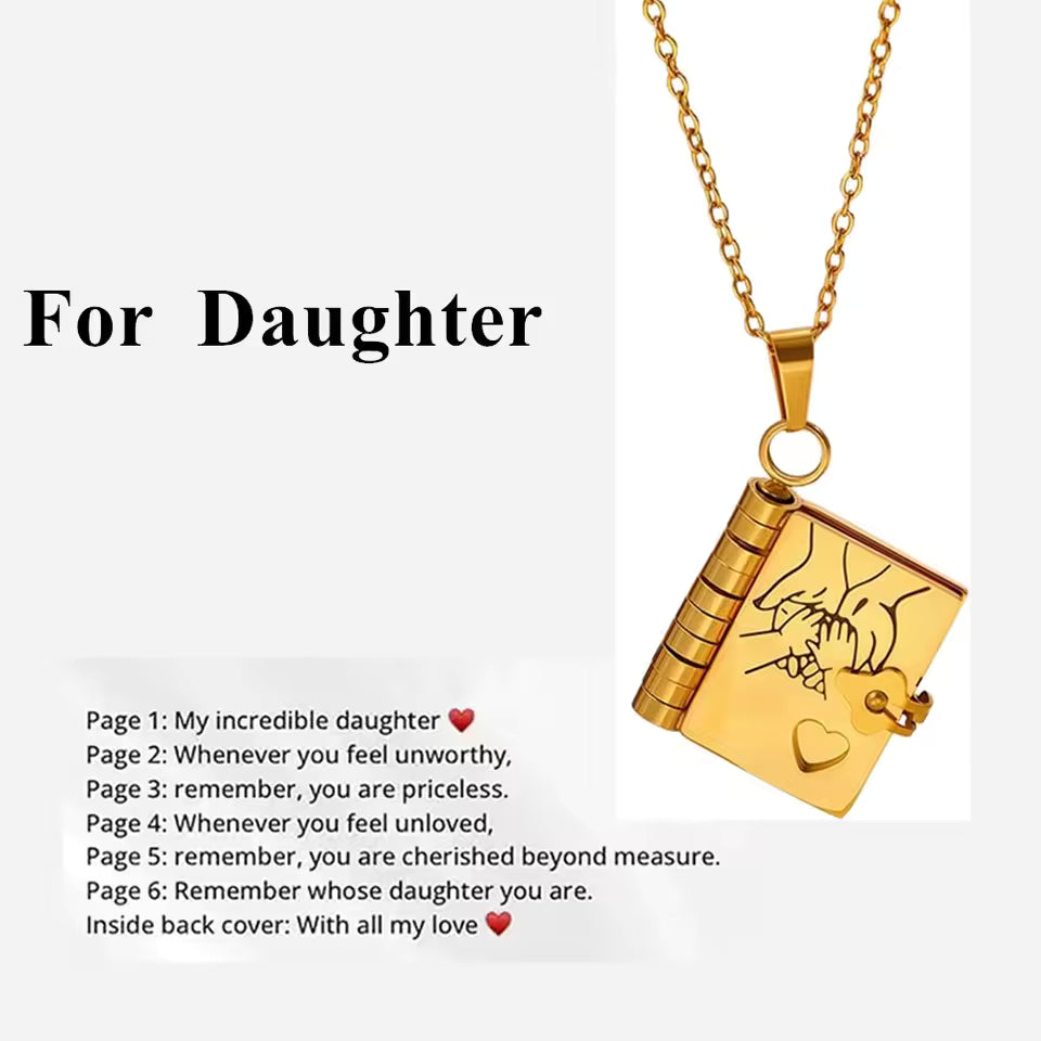 Gold necklace with book-shaped pendant on a white background