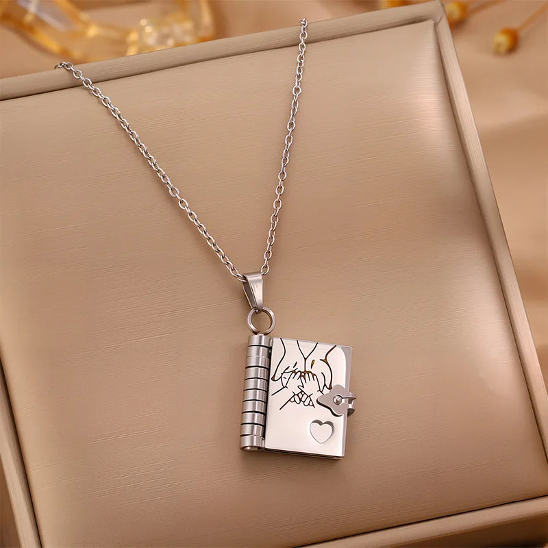 Silver necklace with a lock-shaped pendant on a beige surface
