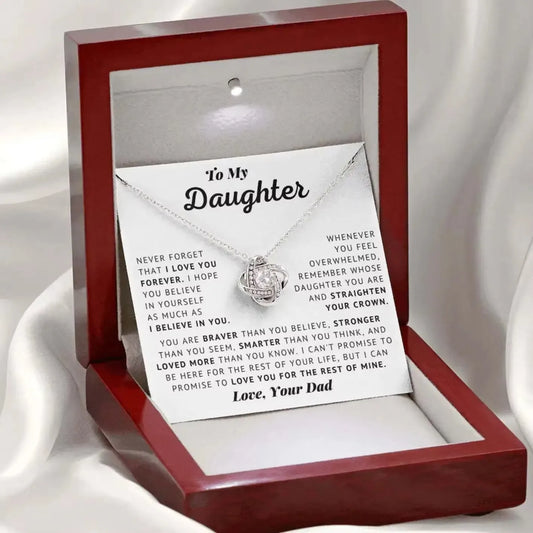 Necklace with engraved message in a wooden box on a white background