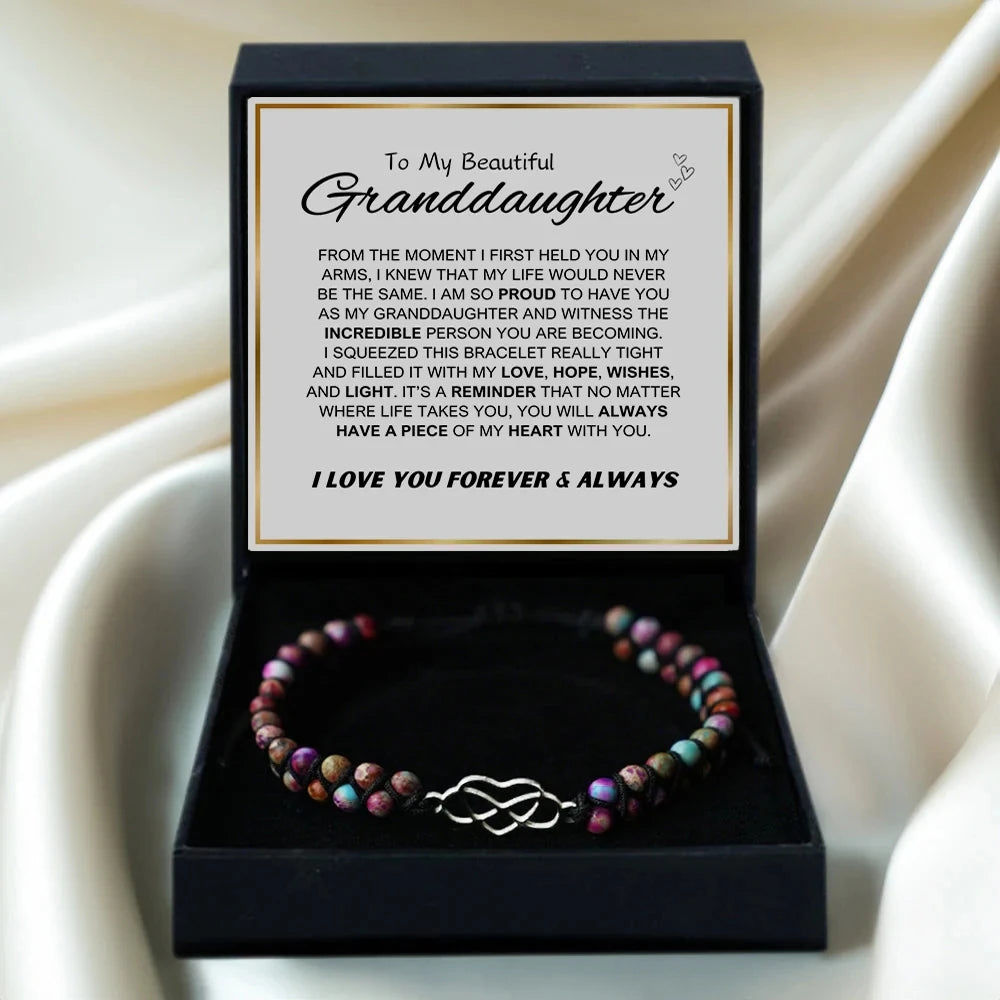Bracelet in a box with a sentimental message for a granddaughter on a beige fabric background