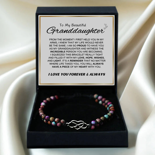 Bracelet in a box with a sentimental message for a granddaughter on a beige fabric background