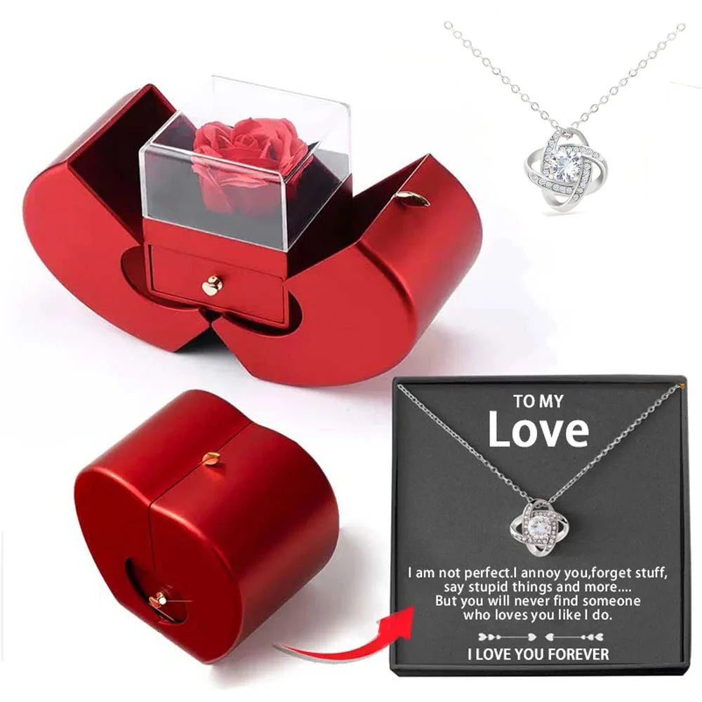 Red jewelry box with a red rose, silver necklace with heart pendant, and black card with 'To My Love' message on a white background.