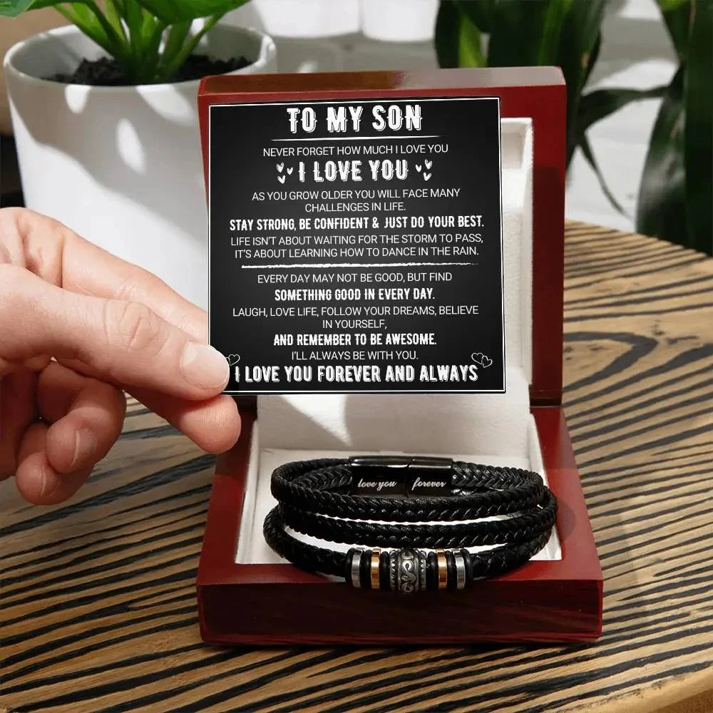 Hand holding a box with leather bracelets and a card inside, set against a blurred indoor background.
