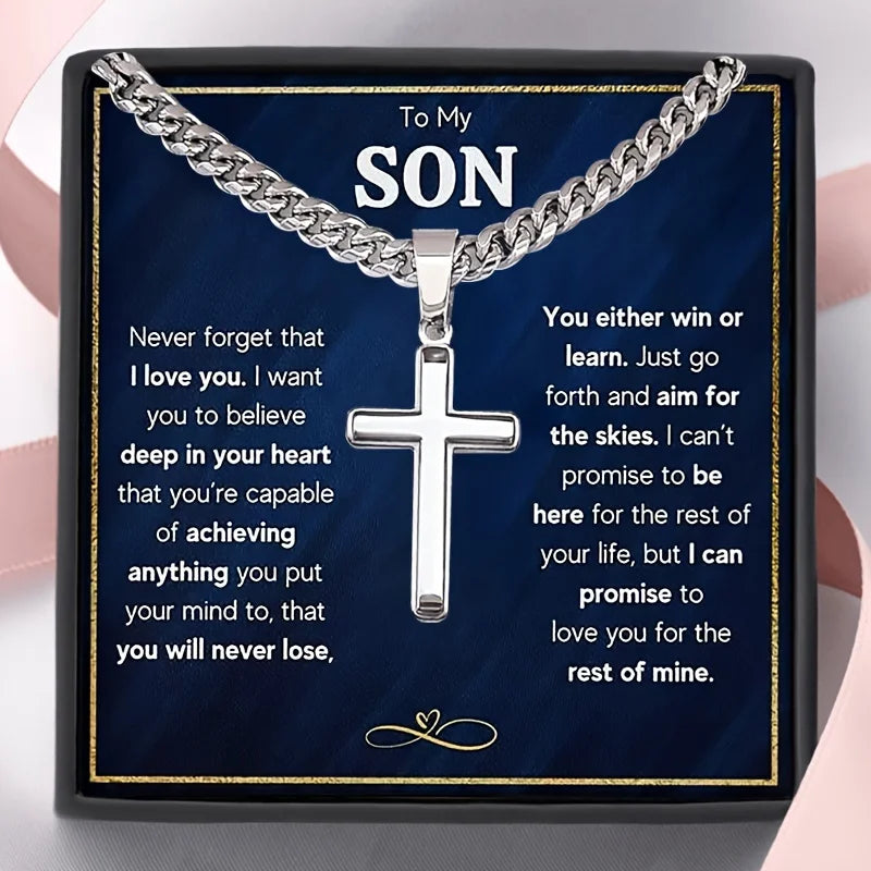 Silver cross necklace with sentimental message card for son on a dark blue background