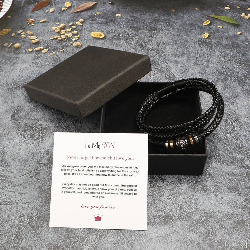 Bracelet with engraved message in a black box on a textured surface