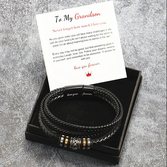 Black braided leather bracelet with gold accents on a card that reads 'To My Grandson' on a gray textured background.