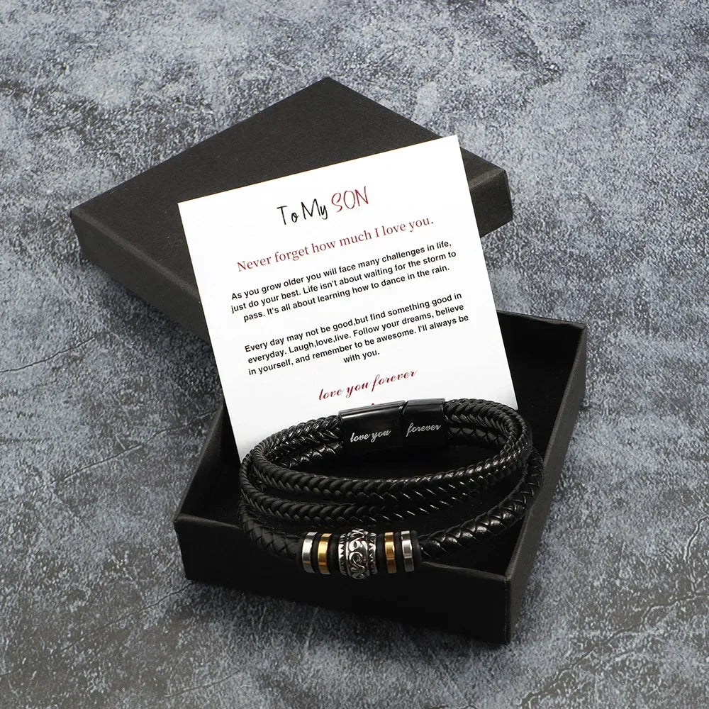 Black braided bracelet set with a card in a black box on a gray textured background