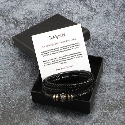 Black braided bracelet set with a card in a black box on a gray textured background