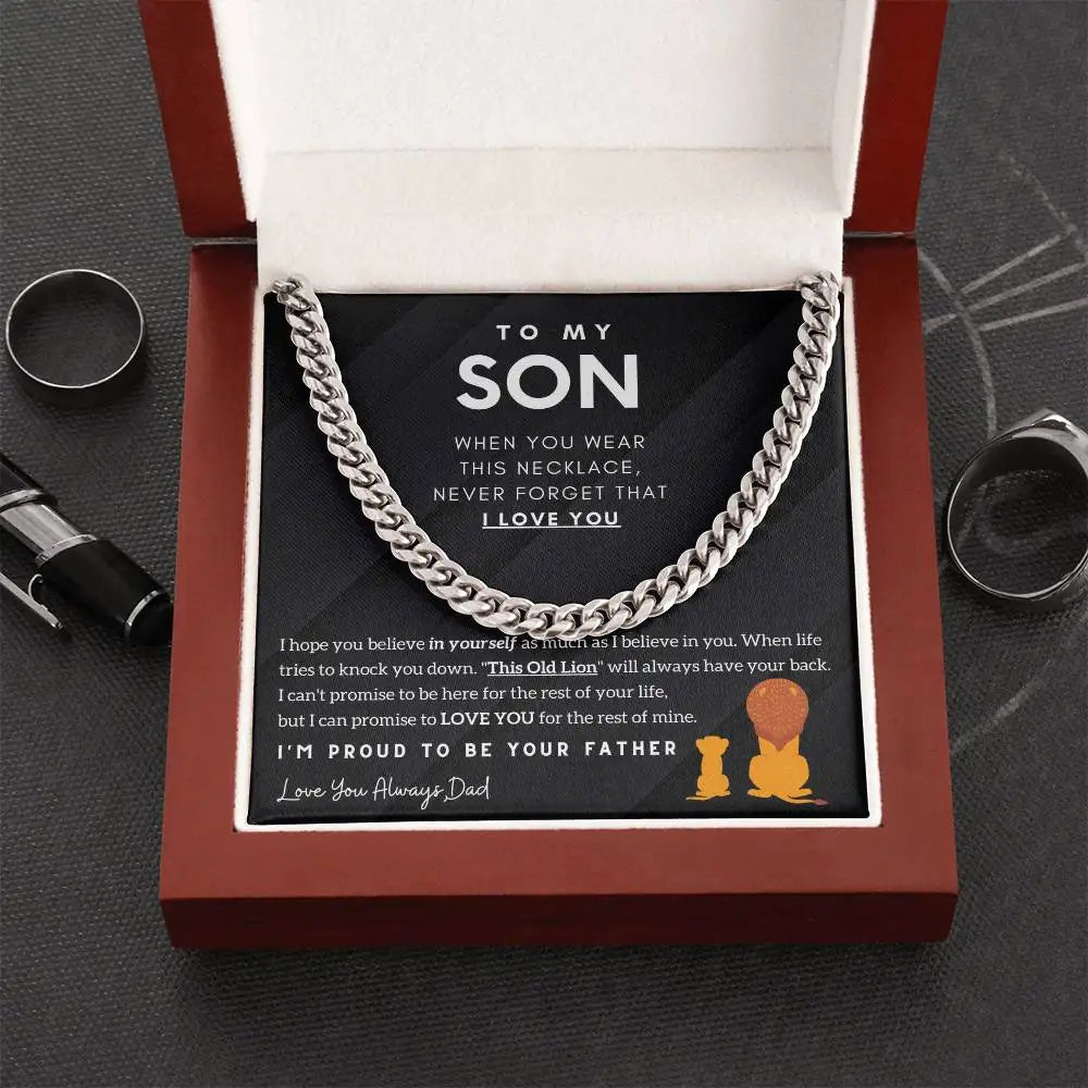 Necklace with a sentimental message card in an open box on a dark surface.