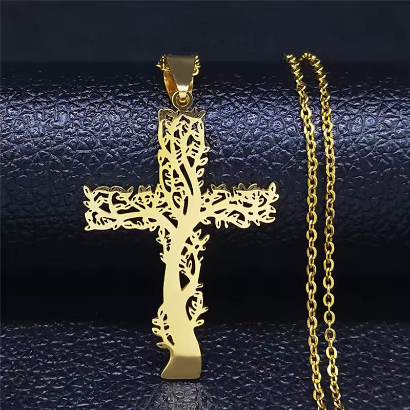 Gold cross pendant with chain on a dark textured background