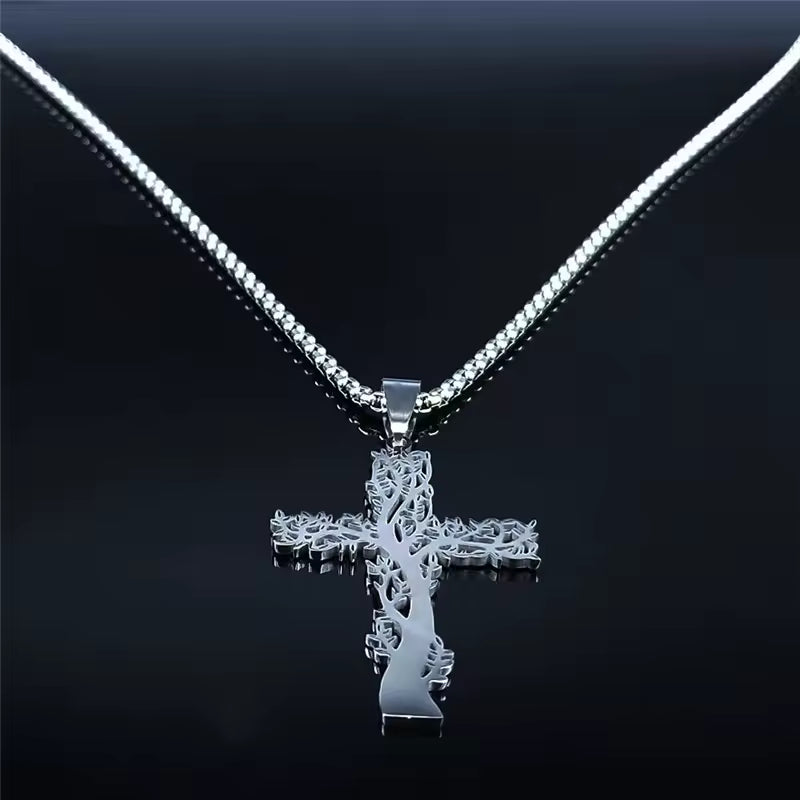 Silver cross pendant necklace on a black background