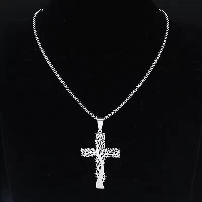 Silver cross pendant necklace on a black background