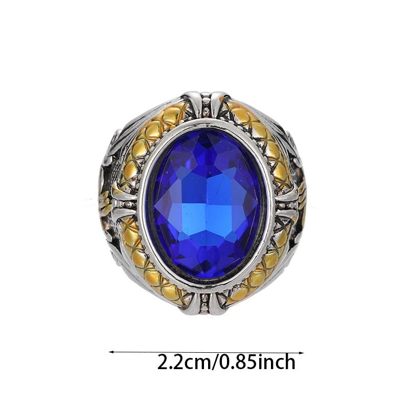 Ring with blue gemstone and gold accents on a white background