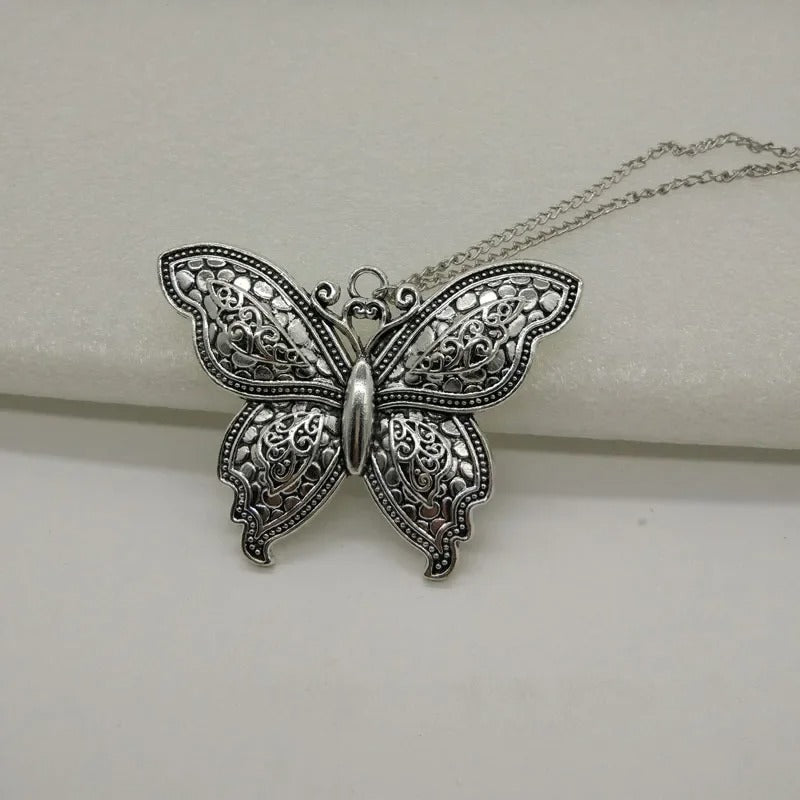 Silver butterfly pendant necklace on a white background