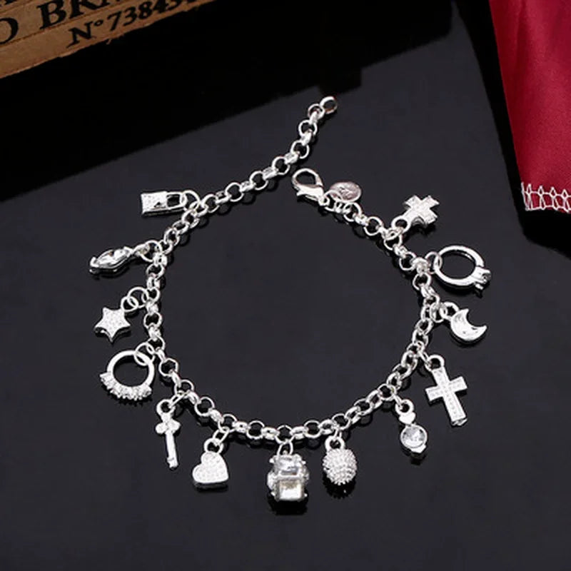 Silver charm bracelet on a dark surface