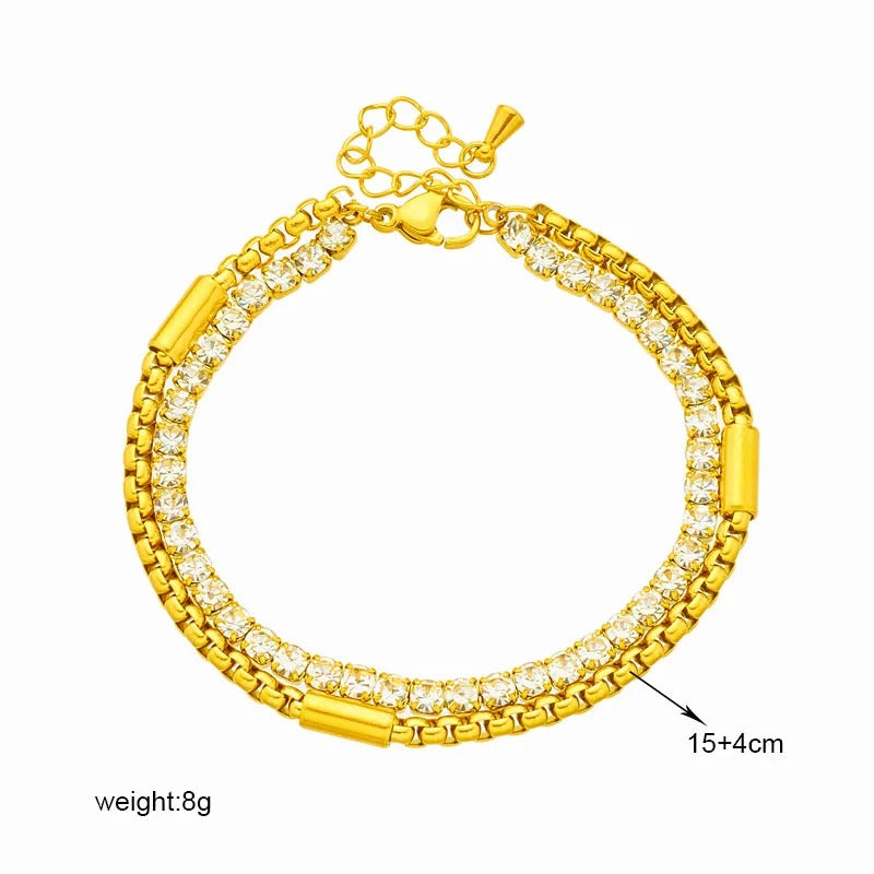 Gold bracelet with clear stones on a white background