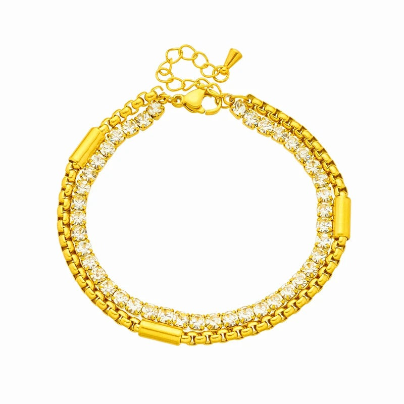 Gold bracelet with clear gemstones on a white background