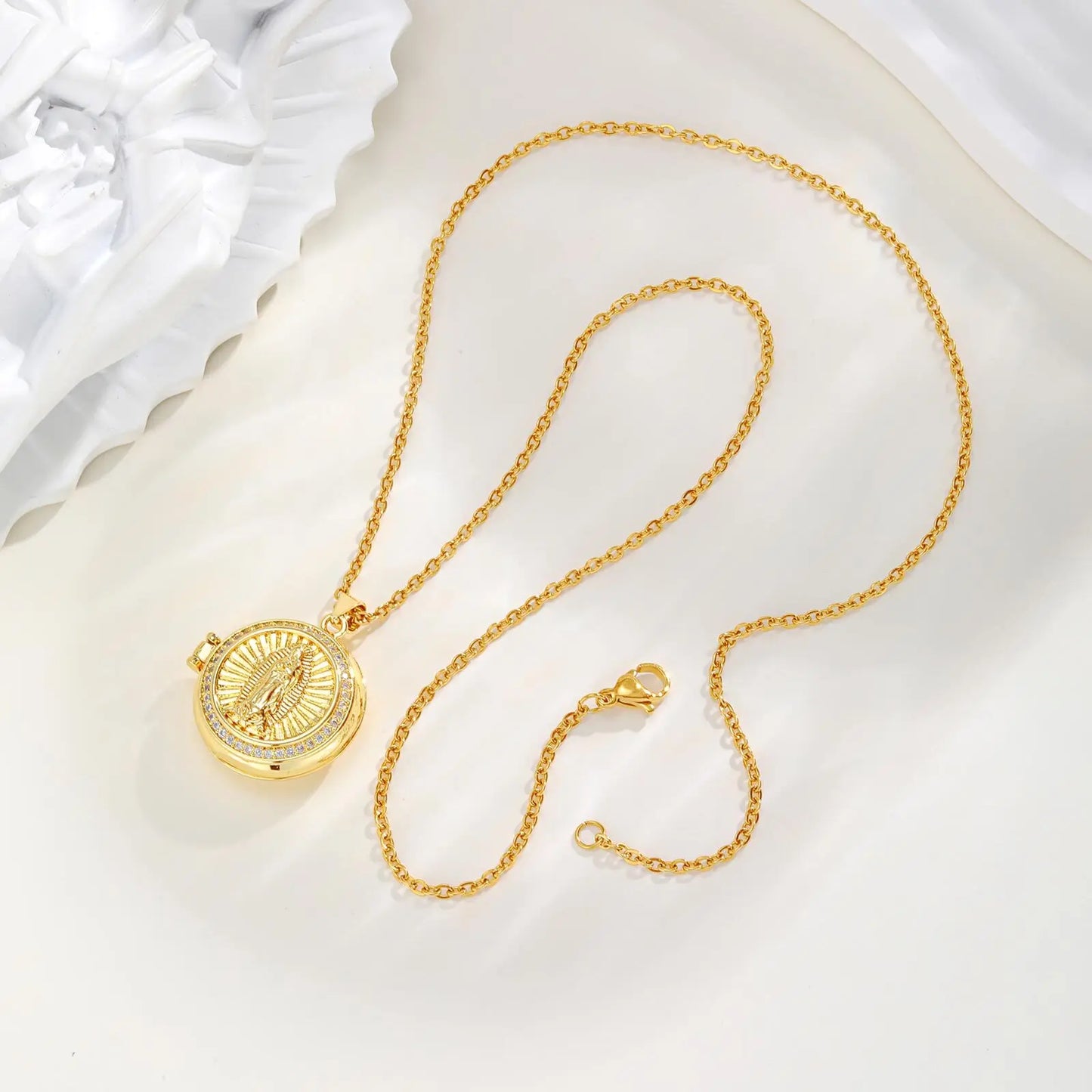 Gold necklace with a pendant on a white background