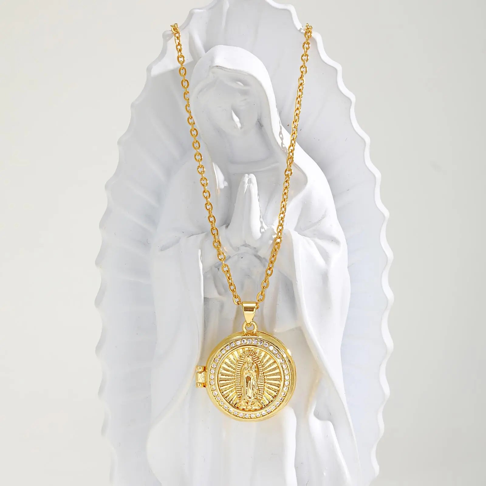 Gold necklace with a pendant on a white background