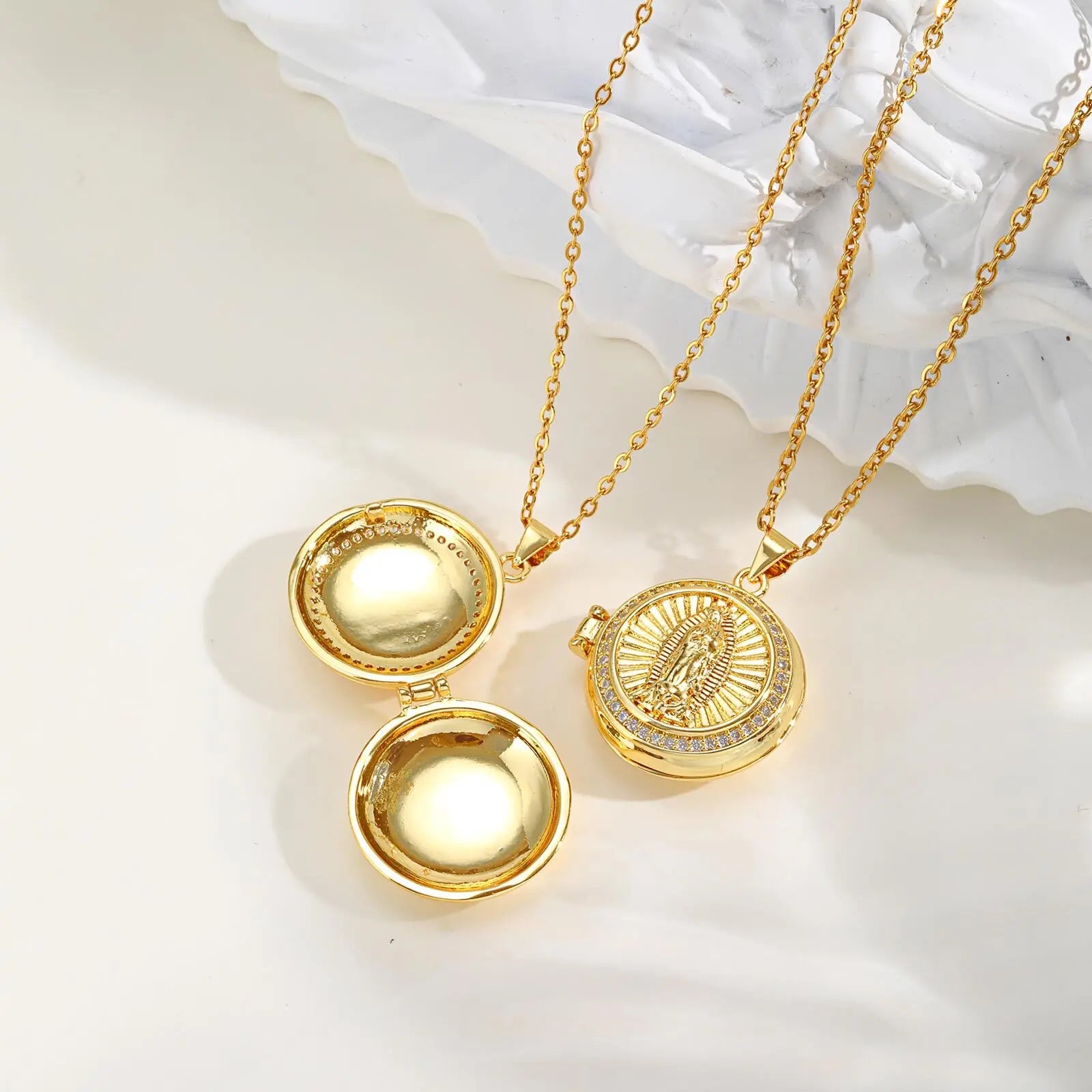 Gold necklace with a pendant on a white background